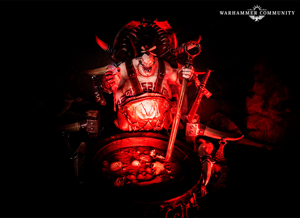 image Frontline Gaming Red lit Warhammer figurine a hulking demon in armor stands over a skull filled cauldron wielding a sword and axe