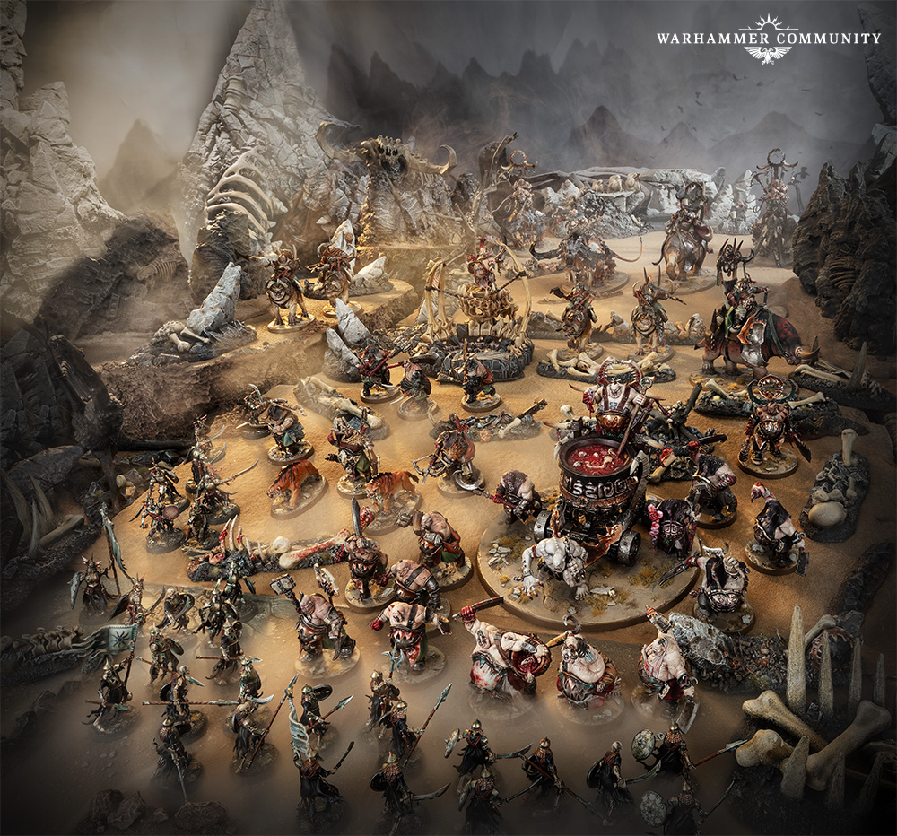 image Frontline Gaming Tabletop Warhammer battle scene with dozens of painted miniatures on a rocky desert board a central siege engine and jagged rock formations in the background