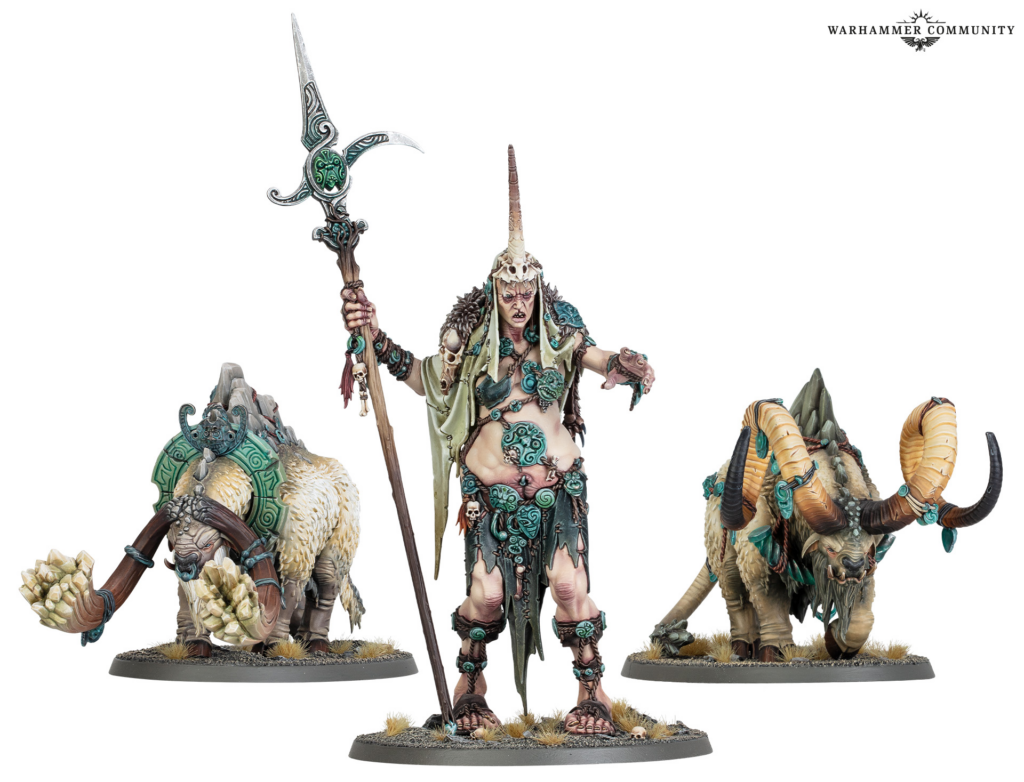 Center figure horned sorceress with staff flanked by two beastly allies on rocky bases Warhammer miniatures display