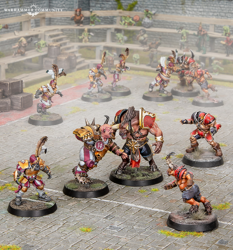 Group of painted Warhammer miniatures on a stone arena battlefield midcombat with a large armored fighter and a beastly foe surrounded by cheering spectators in the stands