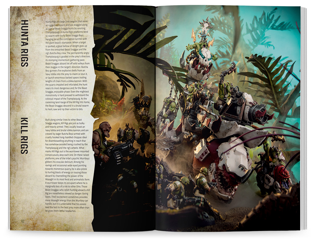 image Frontline Gaming Two page magazine spread featuring a chaotic jungle battle with armored war rigs fighting orc like fighters left page shows text panels labeled HUNTA RIGS and KILL RIGS