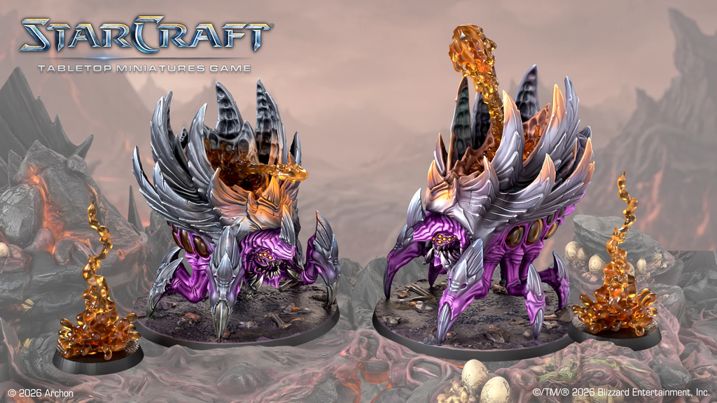 Two purple dragon like StarCraft miniatures on lava terrain with a rocky backdrop