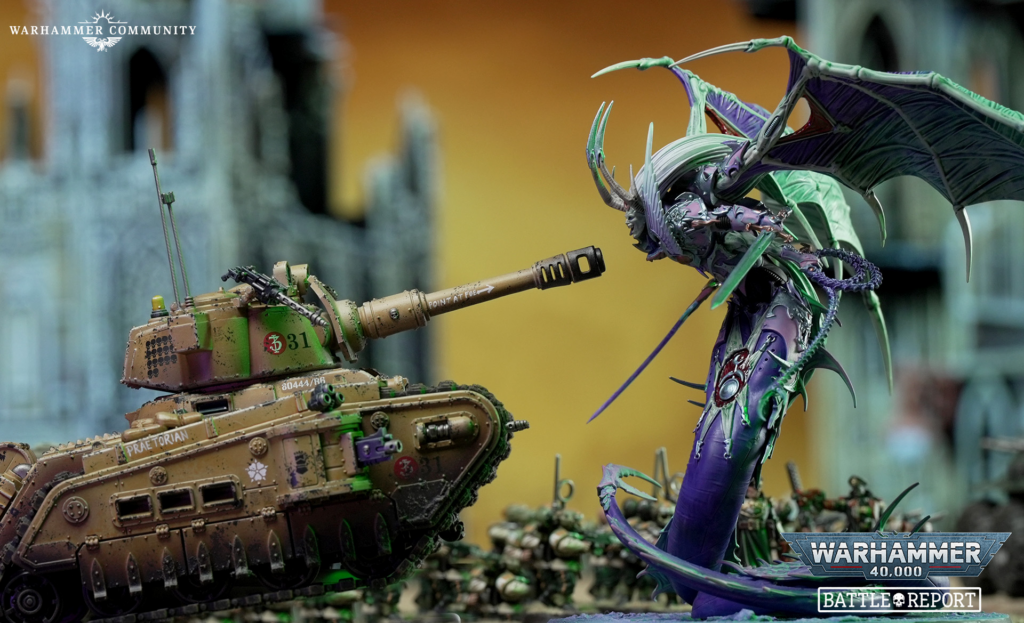 Tank firing at a purple green dragon like creature in a Warhammer diorama Warhammer Community logo in the corner