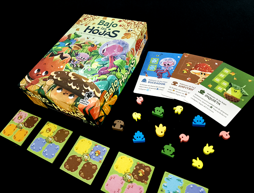 image Frontline Gaming Colorful jungle themed board game box with accompanying character and animal cards and assorted small token pieces laid out on a black surface