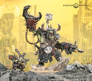 Ork Warboss in spiked armor raises a large melee weapon and fires a gun on a rocky battlefield Warhammer Community logo in the top right