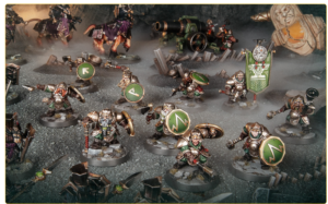Tabletop battle scene with silver green armored miniatures round green shield emblems a banner and ruined battlefield scenery