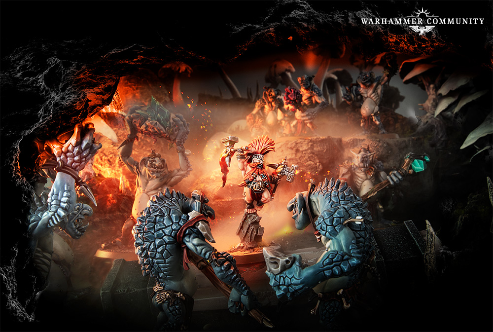 Warhammer miniature battle in a dark cavern a red clad hero clashes with blue rock skinned foes amid fiery glow